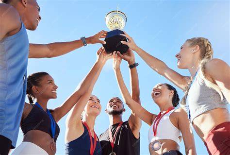 Female athletes proudly holding their awards at an Athletes Unlimited ceremony.