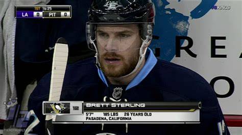 A hockey player receiving an award for achievements on the ice.