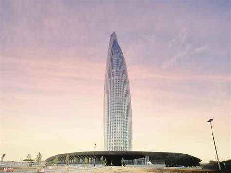 Photographer capturing images of the Mohammed VI Tower from the waterfront promenade.