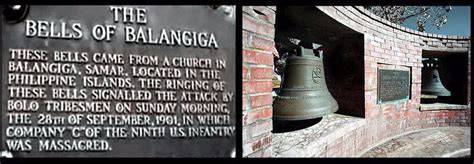 American soldiers standing near the church with the bells in the background