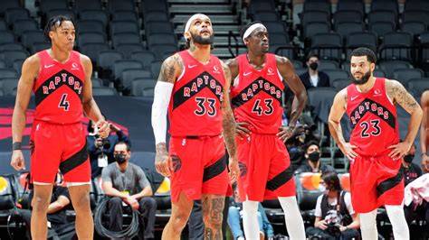 A Toronto Raptors player sitting injured on the bench during a game.