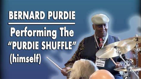 Bernard Purdie energetically performing the Purdie Shuffle at a concert.