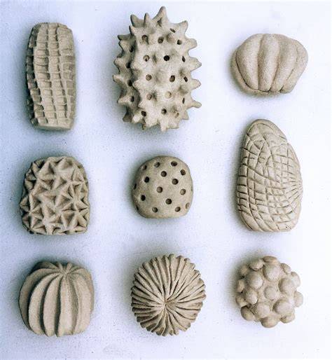 A close-up of hands selecting textured clay for Yaoji ceramic making.