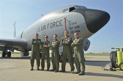 Crew members inside a KC-135 Stratotanker discussing mission plans.