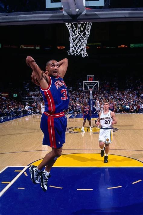 Grant Hill dribbling the ball on the court while playing for the Detroit Pistons.