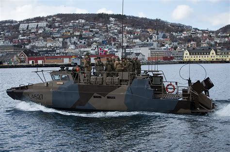 A CB90-class fast assault craft conducting a military drill.