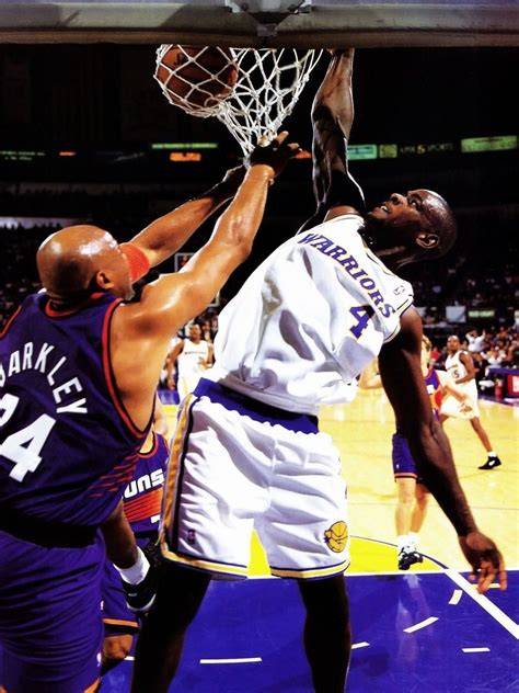 Chris Webber in action during a game for the Warriors, showcasing his skills.