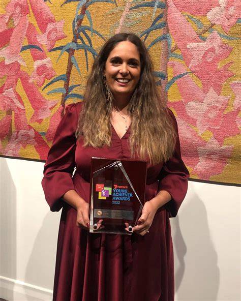 Bonnie Story accepting an award on stage at a theater event
