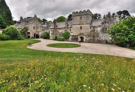 The entrance sign of Cotehele set against a picturesque landscape.