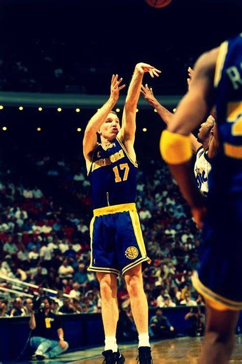 Chris Mullin practicing shooting in a gym