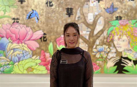 Asian artists presenting their work at a contemporary art exhibition.