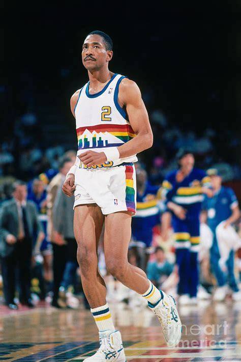 Alex English dribbling the ball during a game for the Denver Nuggets.