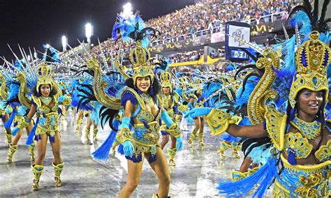 A crowd enjoying a Brazilian music performance with colorful costumes.