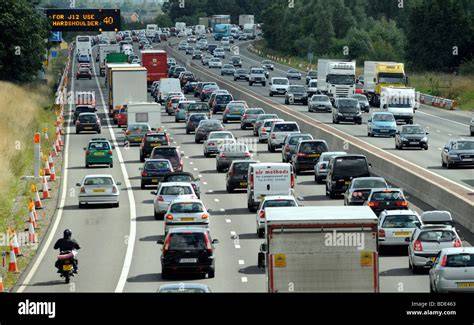 Sign showing junction 10 on the M6 motorway congested with vehicles.