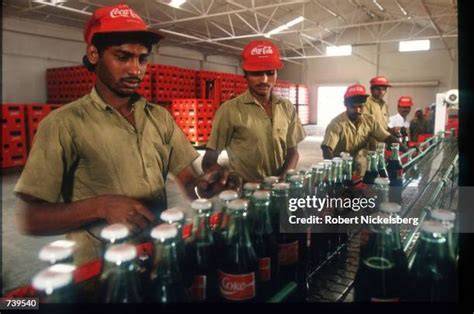 Workers in a Coca-Cola factory in India engaged in production.