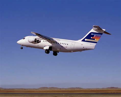 Ansett Australia jet aircraft flying above the clouds with a clear blue sky.